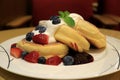 Mouthwatering Fluffy Souffle Pancake with Fresh Whipped Cream and Mix Berries Served on white Plate Royalty Free Stock Photo