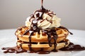 Pouring chocolate syrup on fresh delicious homemade waffles