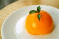 Mouthwatering Mandarin Orange Cake Dome on a White Plate