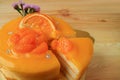 Mouthwatering mandarin orange cake with one piece cut from the whole cake