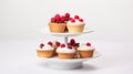 Delicious Raspberry Cupcakes On A Three Layer Plate