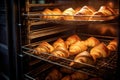 A mouthwatering sight of a variety of croissants beautifully baking in the oven, fresh croissants in rack in bakery oven, AI Royalty Free Stock Photo