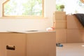 Move. Cardboard boxes for moving into a new, clean home. In a sunny day by a window in attic Royalty Free Stock Photo