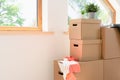 Move. Cardboard boxes for moving into a new, clean home. In a sunny day by a window in attic Royalty Free Stock Photo