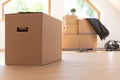 Move. Cardboard boxes for moving into a new, clean home. In a sunny day by a window in attic Royalty Free Stock Photo