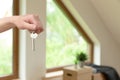 Move. Cardboard boxes for moving into a new, clean home. In a sunny day by a window in attic. Beautifull women holding boxes Royalty Free Stock Photo