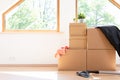 Move. Cardboard boxes for moving into a new, clean home. In a sunny day by a window in attic Royalty Free Stock Photo