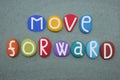 Move forward, creative slogan composed with stone letters over green sand Royalty Free Stock Photo