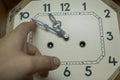 Move the hands of a large mechanical clock by hand