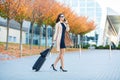 Always on the move. Woman walking in airport and talk at mobile