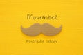 Movember cancer awareness event concept over wooden background. Top view