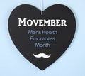 Movember fundraising for mens health awareness message on blackboard Royalty Free Stock Photo