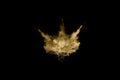 Golden powder explosion on black background. Freeze motion.