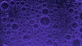 Movement of bubbles in liquid. Violet color.