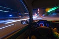 Movement of the car at night on the country highway at a high speed of viewing from the inside with the driver. Hand on Royalty Free Stock Photo