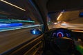 Movement of the car at night on the country highway at a high speed of viewing from the inside with the driver. Hand on Royalty Free Stock Photo