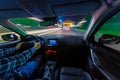 Movement of the car at night at a speed view from the interior, Brilliant road with lights with a car at high speed Royalty Free Stock Photo