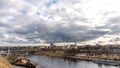 The movement of gray rain clouds over the river and a panorama of the city. View of the embankment along the river and the road Royalty Free Stock Photo