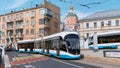 Movement of modern passenger streetcars along Yauza Boulevard against the background of the Church of Peter and Paul