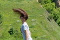 Movement raise on head hair up in the air. Portrait carefree woman with long brown hair.