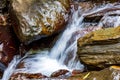 Movement of river water flowing between rocks Royalty Free Stock Photo