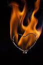 The movement of the smoke and flame rising on a heart shape on a black background Royalty Free Stock Photo