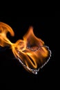 The movement of the smoke and flame rising on a heart shape on a black background Royalty Free Stock Photo