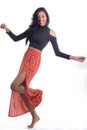 Movement. Spontaneous. Funny. Afrodescendant woman wearing orange skirt..