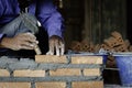 The movement of trowel putty knife Bricklayer worker installing brick masonry on interior wall with in Construction Site Royalty Free Stock Photo