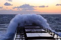 The movement of the vessel against the waves during a heavy storm. Sunset.North Pacific ocean. Royalty Free Stock Photo