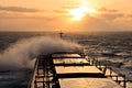 The movement of the vessel against the waves during a heavy storm. Sunset.North Pacific ocean. Royalty Free Stock Photo