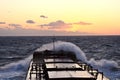 The movement of the vessel against the waves during a heavy storm. Sunset.North Pacific ocean. Royalty Free Stock Photo