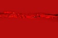 The movement of water on a red background. Royalty Free Stock Photo