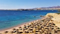 Movenpick resort hotel, beach with pier, lounge chairs and umbrellas in Naama bay Royalty Free Stock Photo