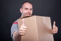 Mover guy holding box showing double like gesture Royalty Free Stock Photo