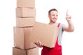 Mover guy holding cardboard box using invisible touch screen Royalty Free Stock Photo