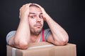 Mover guy holding head looking in trouble Royalty Free Stock Photo