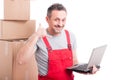 Mover guy holding laptop making calling gesture