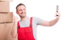 Mover guy pointing box and taking selfie and smiling