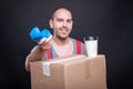 Mover guy smiling offering telephone having coffee