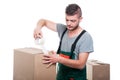 Mover guy using duct tape on cardboard box Royalty Free Stock Photo