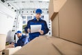 Mover Looking At His Partner Writing On Clipboard Royalty Free Stock Photo