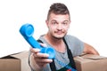 Mover man holding cardboard box handing telephone receiver Royalty Free Stock Photo