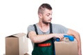 Mover man holding cardboard box putting dow telephone receiver Royalty Free Stock Photo