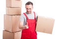 Mover man holding cardboard box using invisible touch screen Royalty Free Stock Photo