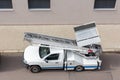 Mover service lifting ladder cargo crane platform vehicle van parked at city street. Retractable furniture elevator