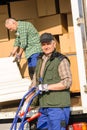 Mover two man loading furniture on truck Royalty Free Stock Photo