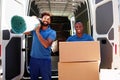 Movers Doing Furniture And Carpet Removal From Truck Royalty Free Stock Photo