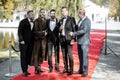 Movie actors on the red carpet outdoors