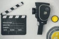 A movie camera, a clapperboard, a film box and a yellow filter Royalty Free Stock Photo
